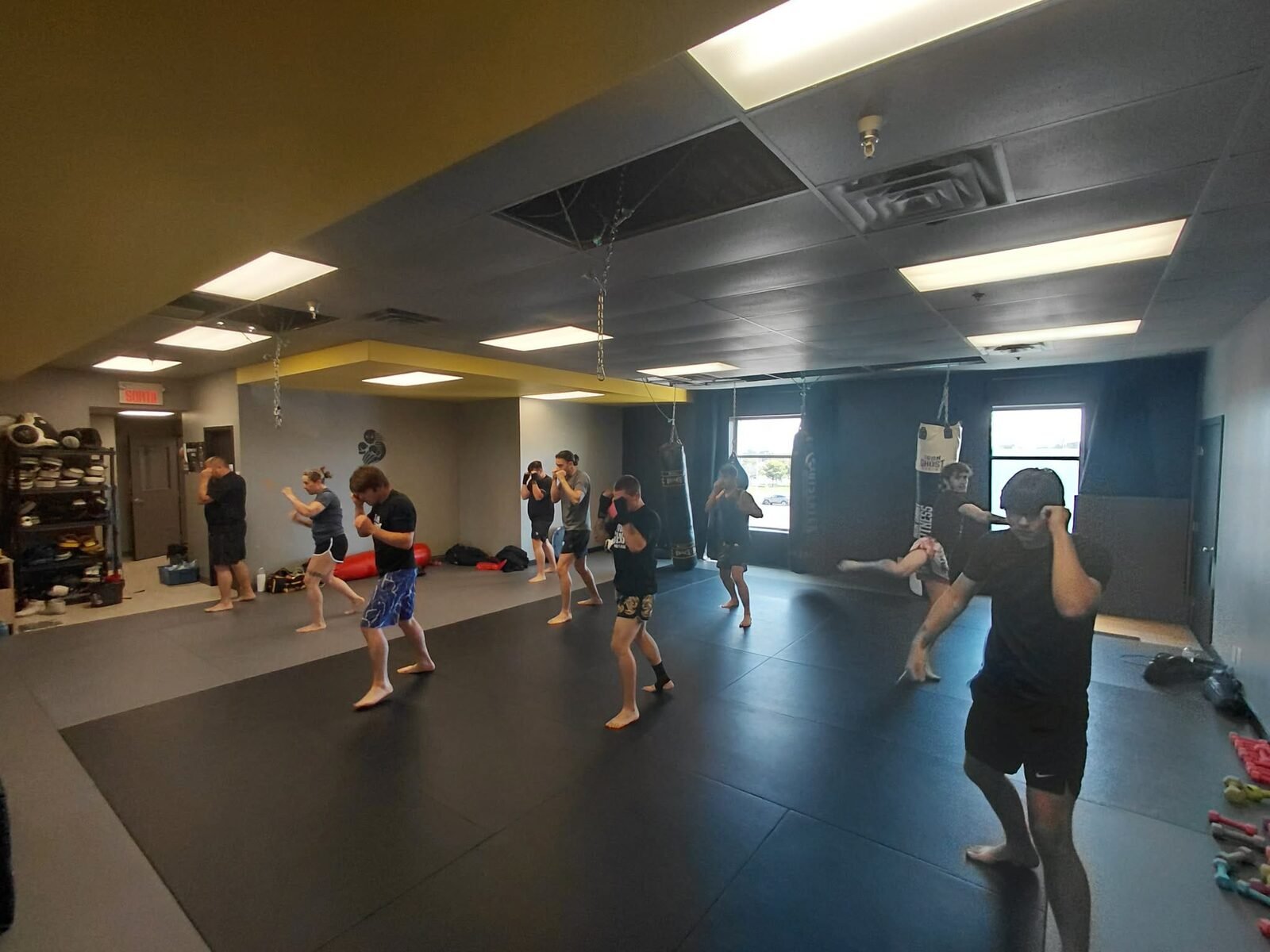 Cours de groupe dans la salle Iron Ghost, au milieu des sacs d'entraînement
